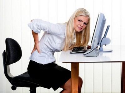 Woman with pain in the back office